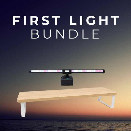 First Light Bundle: Aurora RGB light bar floating above the light-wood Plinth monitor riser
