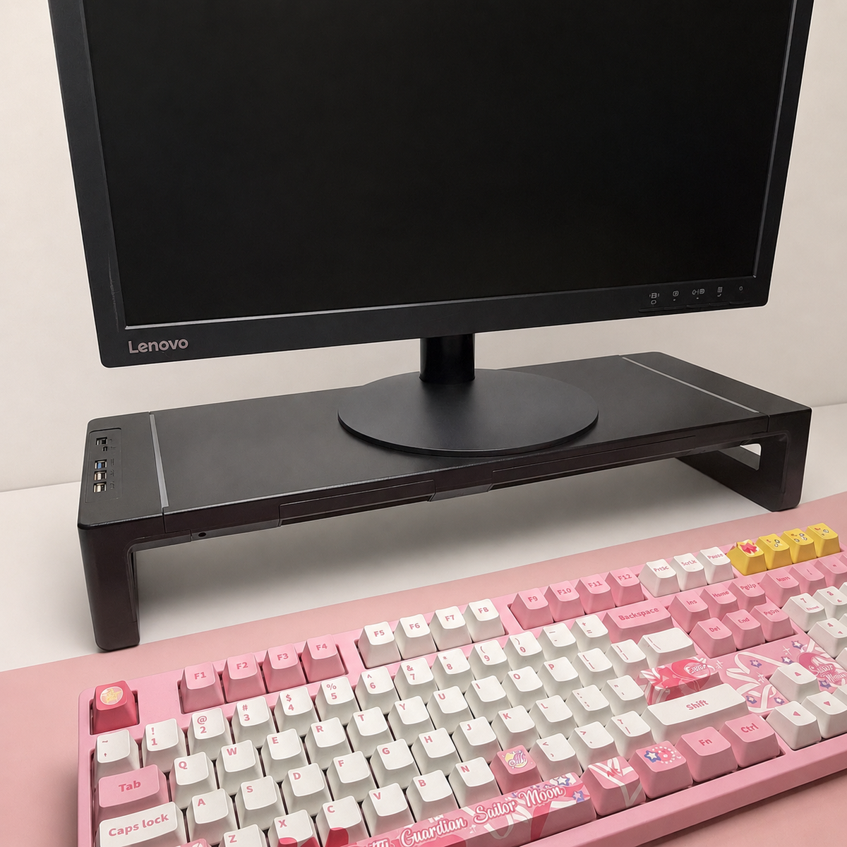 Command Monitor Riser with USB Hub by Voydesk, black riser lifting a monitor above a keyboard