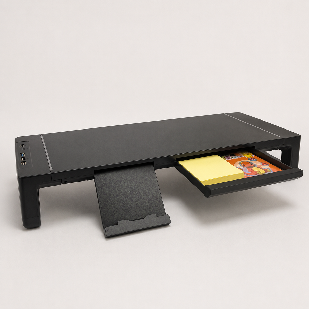 Command riser with its drawer pulled open, holding sticky notes and small items, phone stand extended